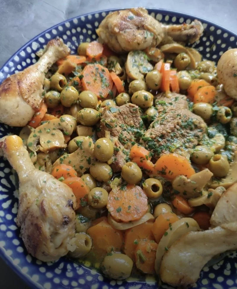 Image d'une photographie d'un plat de tajine de poulet et d'olives algérien.